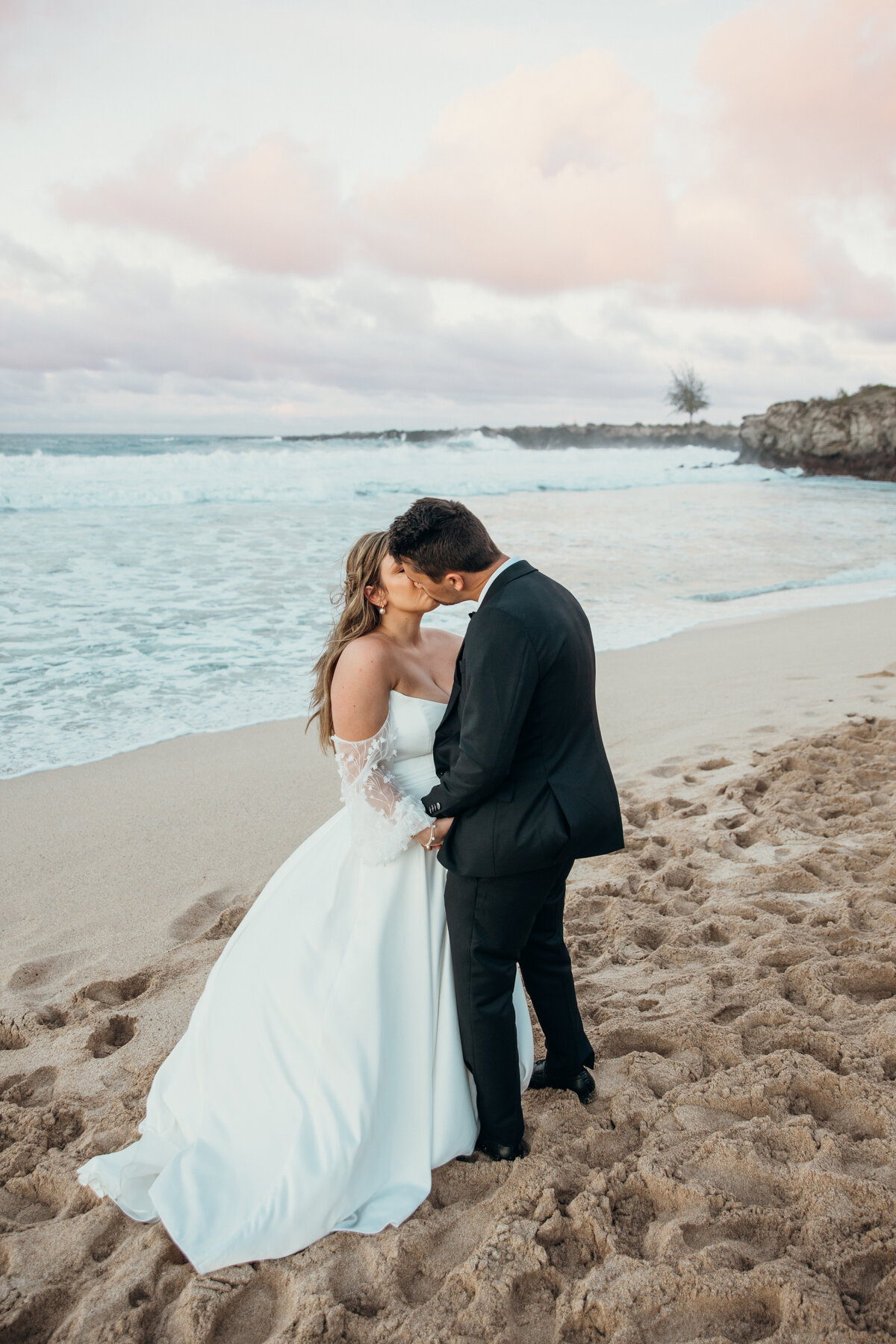 Maui Wedding Photographer captures bride and groom kissing at beach