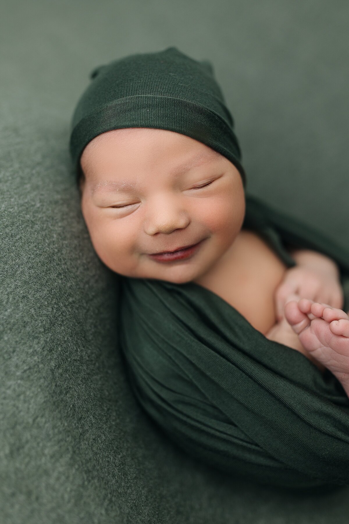 Smiling baby boy newborn photography studio 