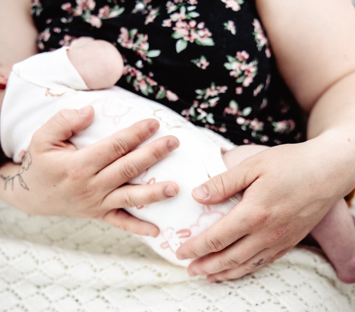 A new mom breastfeeds her two day old baby in her Edmonton home