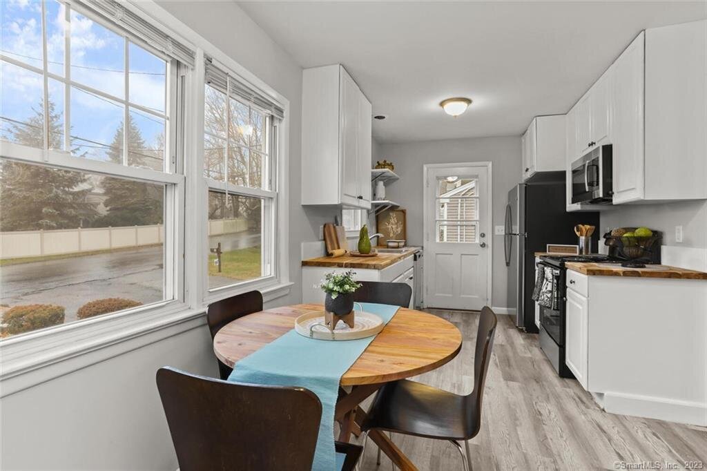 seating area and white kitchen