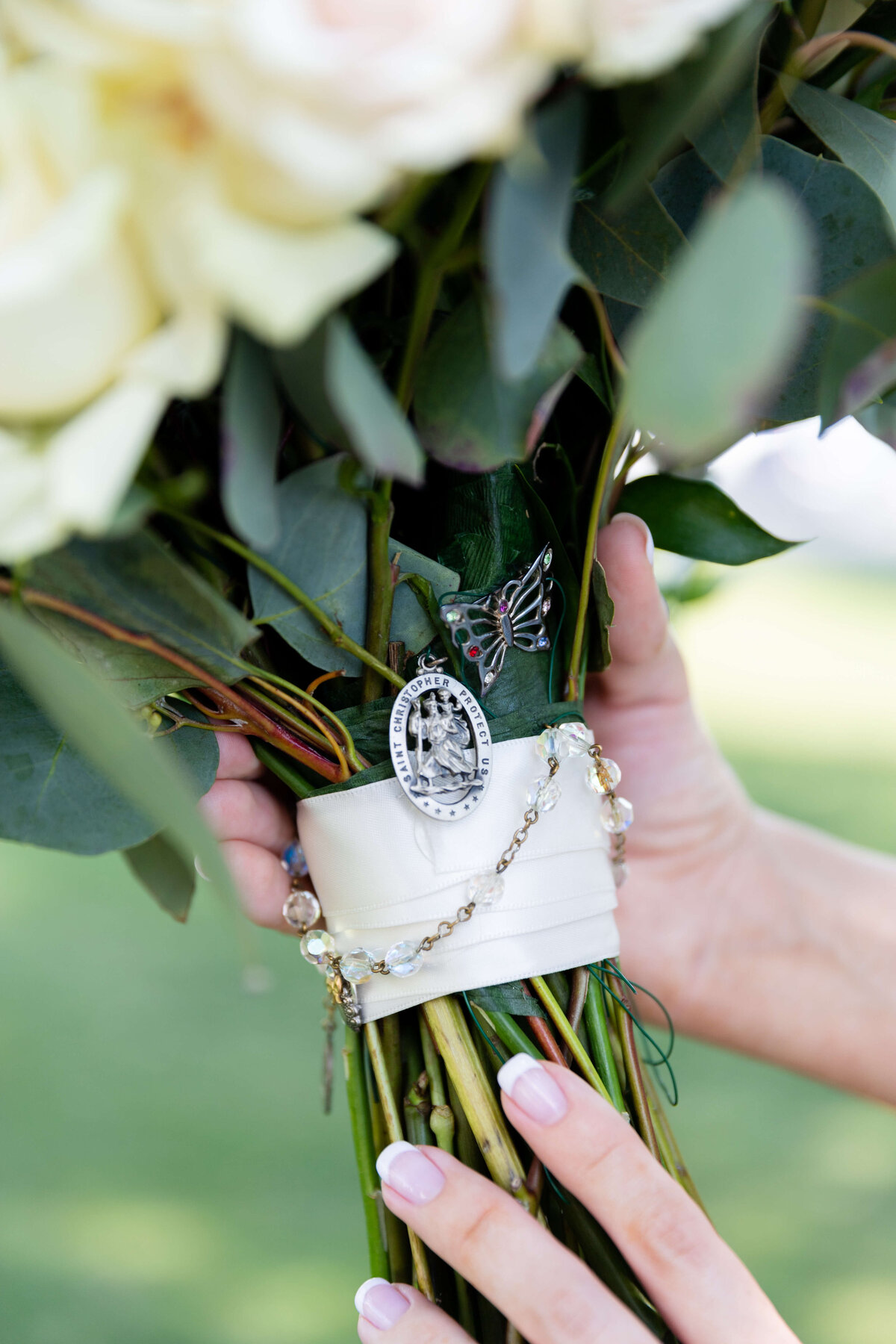 Close up of wedding bouquet with broach at wedding at Stones River Country Club