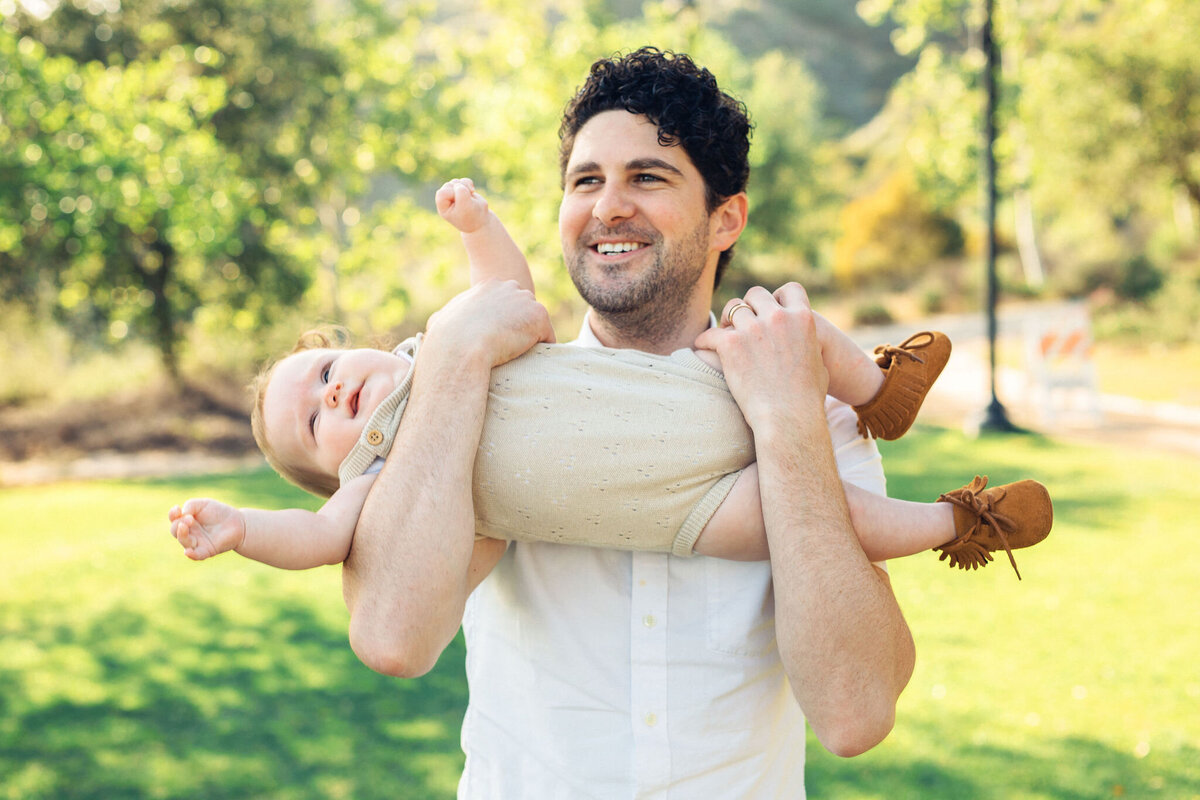 Family Portrait Photo Of Father Carrying His Baby In a Funny Way Los Angeles