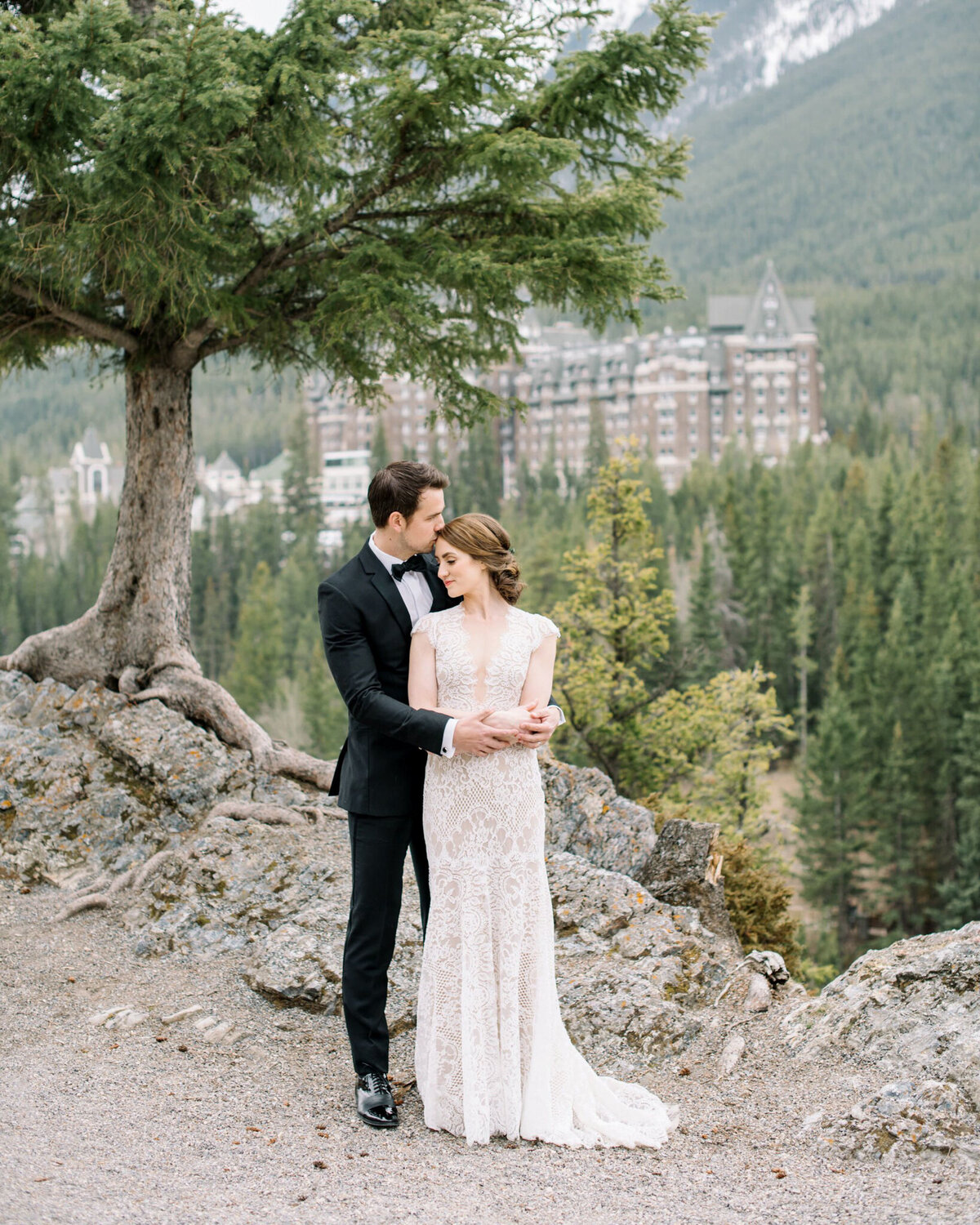 Couple embracing in Banff captured by Corrina Walker Photography, timeless and elegant wedding photographer in Calgary, Alberta. Featured on the Bronte Bride Vendor Guide.
