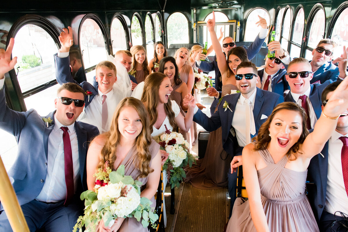 fun wedding photo of friends cheering on the trolley at oglebay resort west virginia
