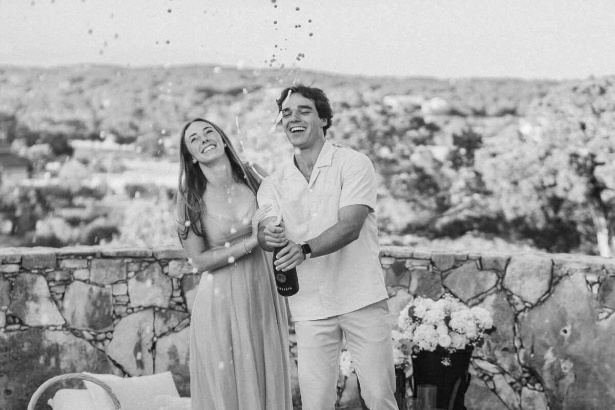 engaged-couple-pops-champagne