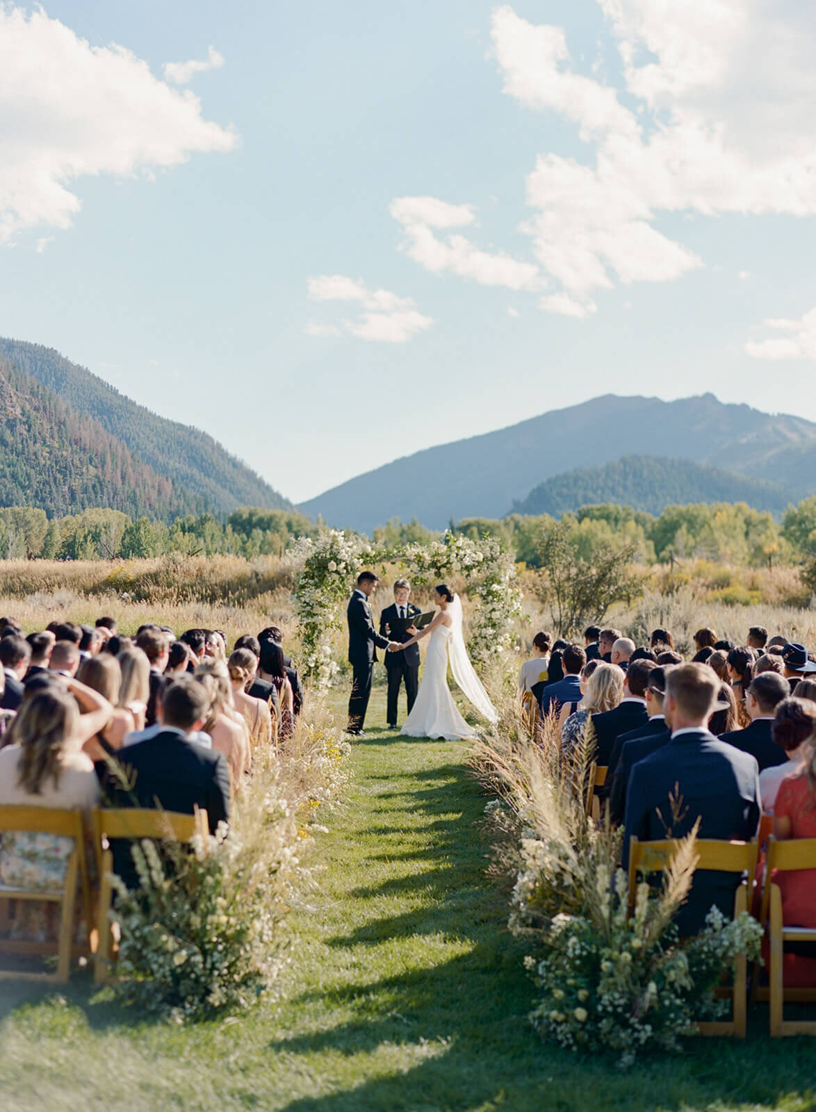 Wide shot view of the wedding ceremony aisle at the Aspen Meadows Resort outdoor Colorado wedding venue.