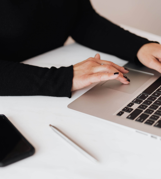 woman looking at laptop on desk