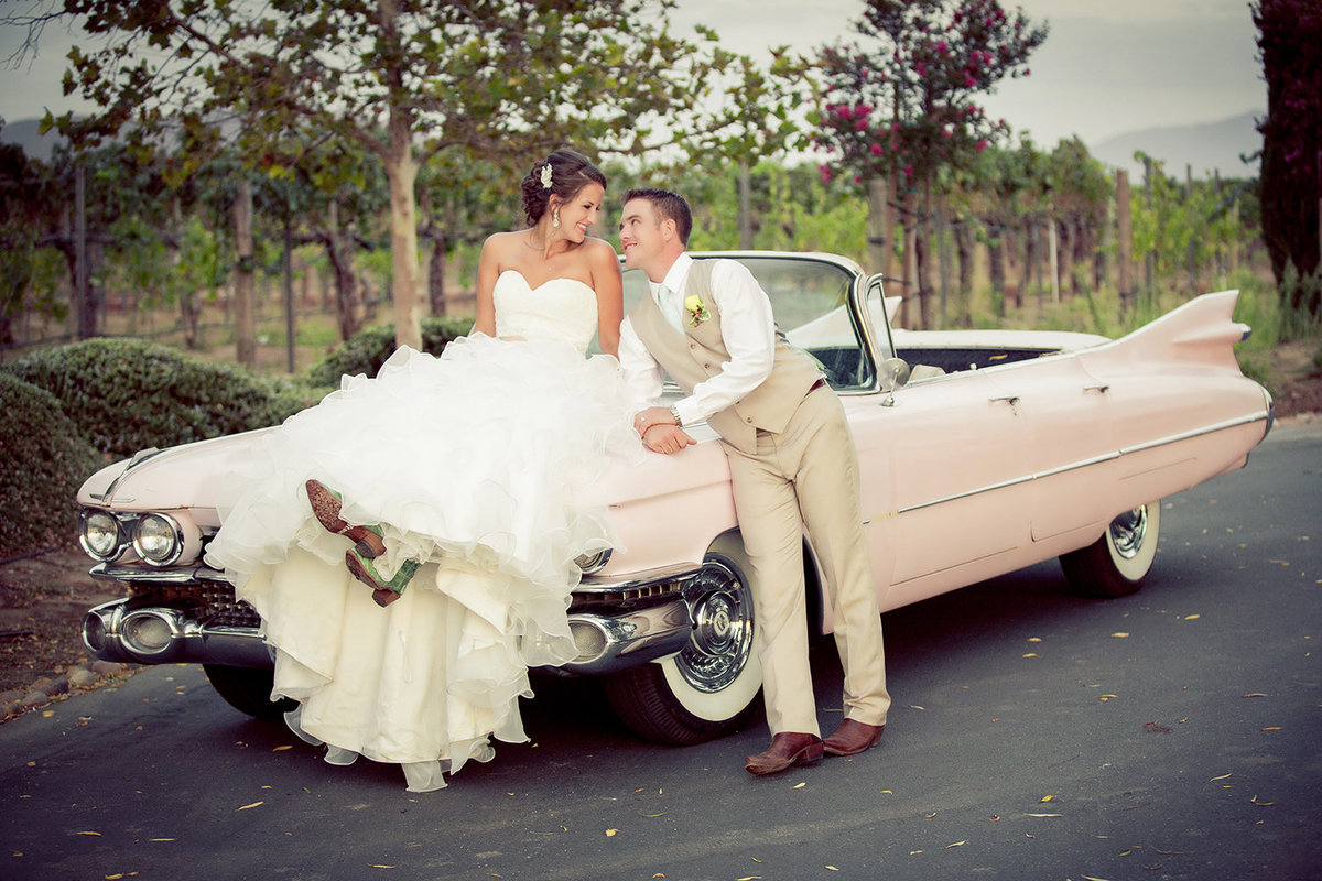 Destination wedding photos vintage car with bride and groom