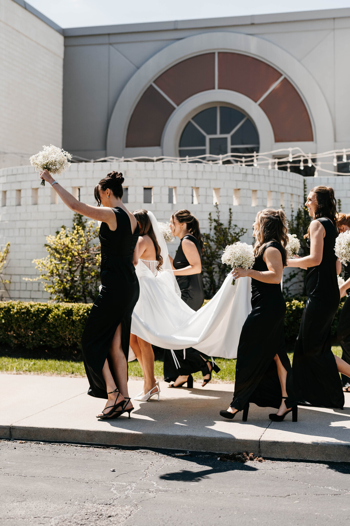 Bridesmaids walking with bride