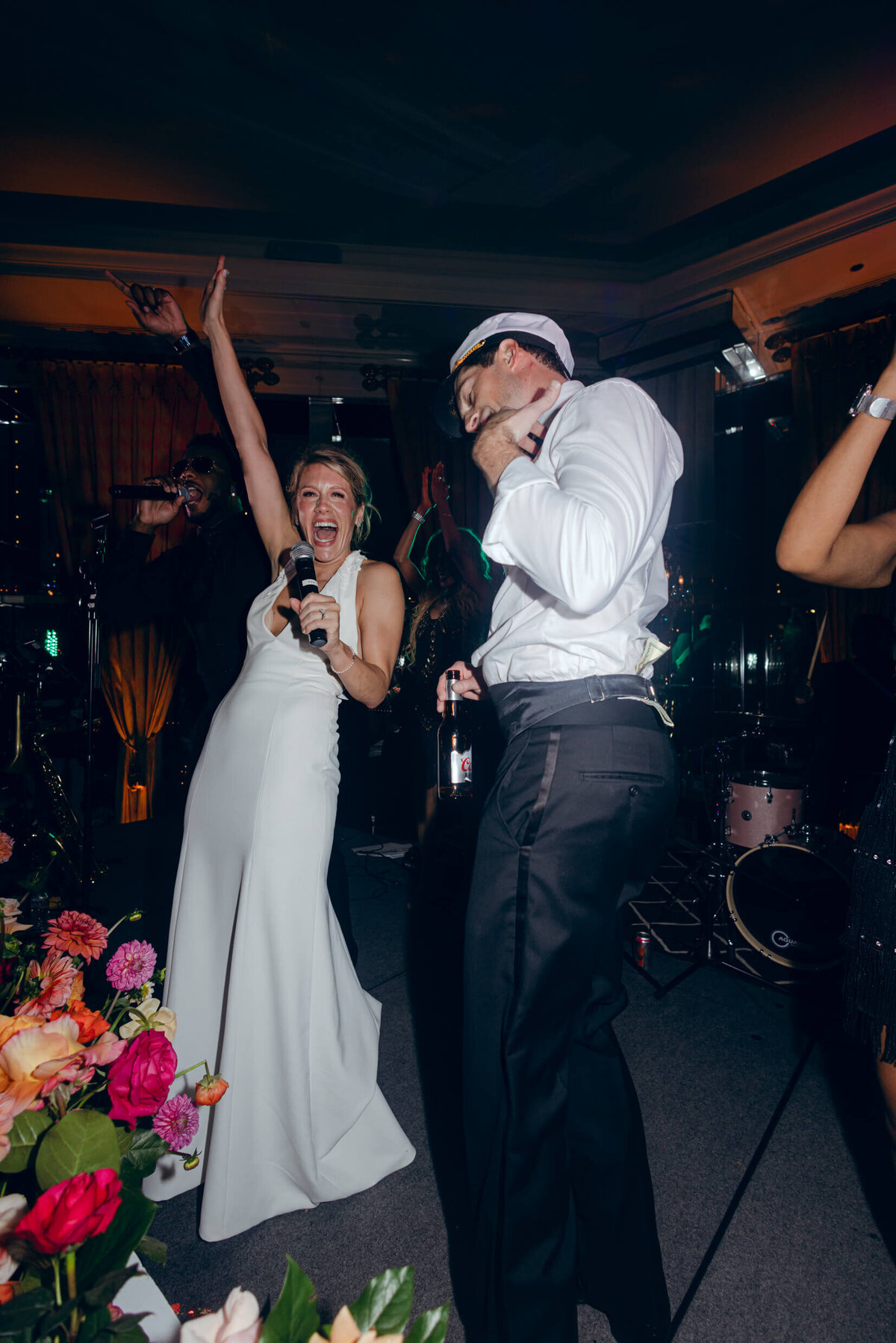 A wedding photo of the bride and groom during a candid moment during their wedding reception