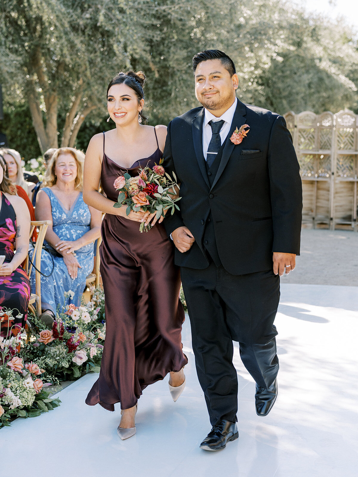 Bridesmaids and groomsmen walk of the ceremony aisle at Ella Brito resort and spa in Paso Robles allegretto