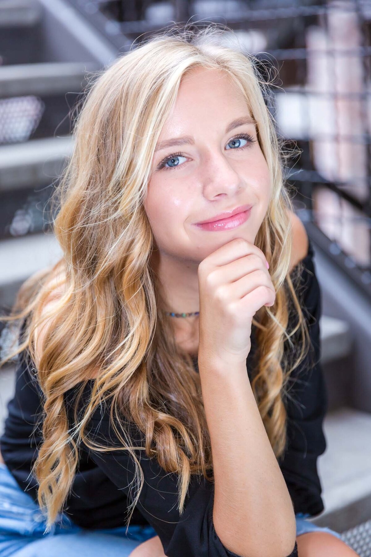 Sassy senior girl with beautiful blonde hair posing on the steps at Ponce City Market in Atlanta.