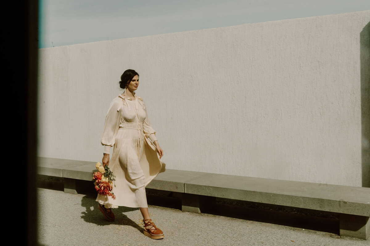 The Lovers Elopement Co - bride walks with floral bouquet