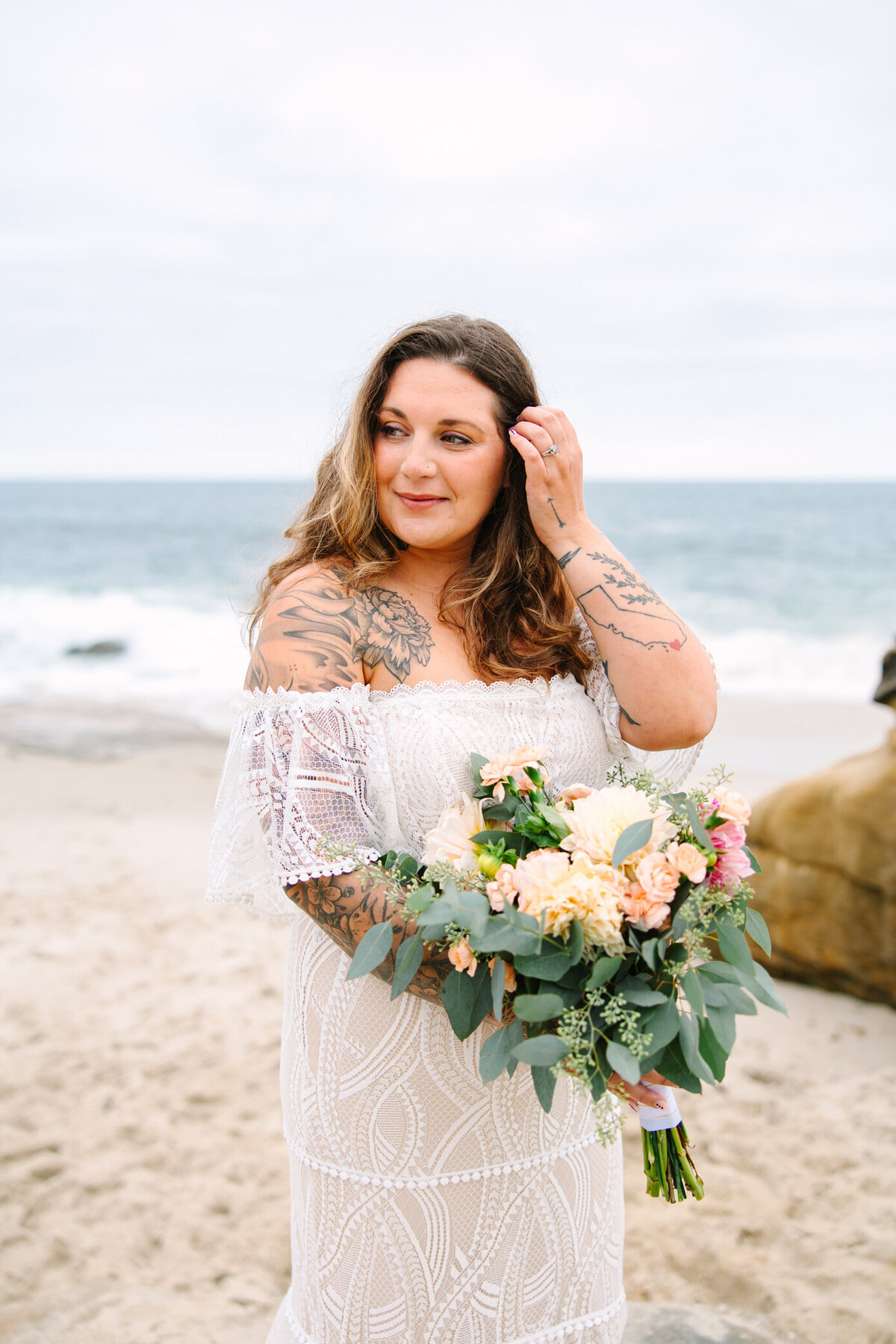 tattooed bride holds bridal bouquet.jpg