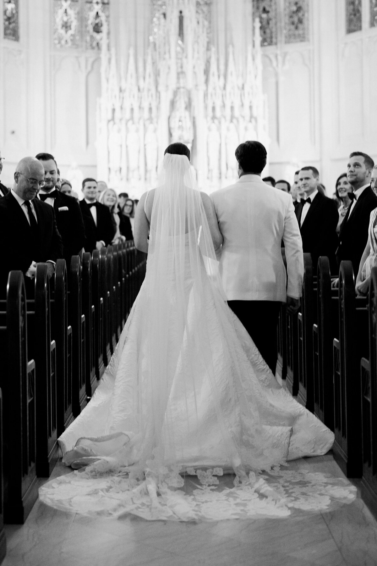Bride and groom walking down the aisle in a solemn church ceremony.