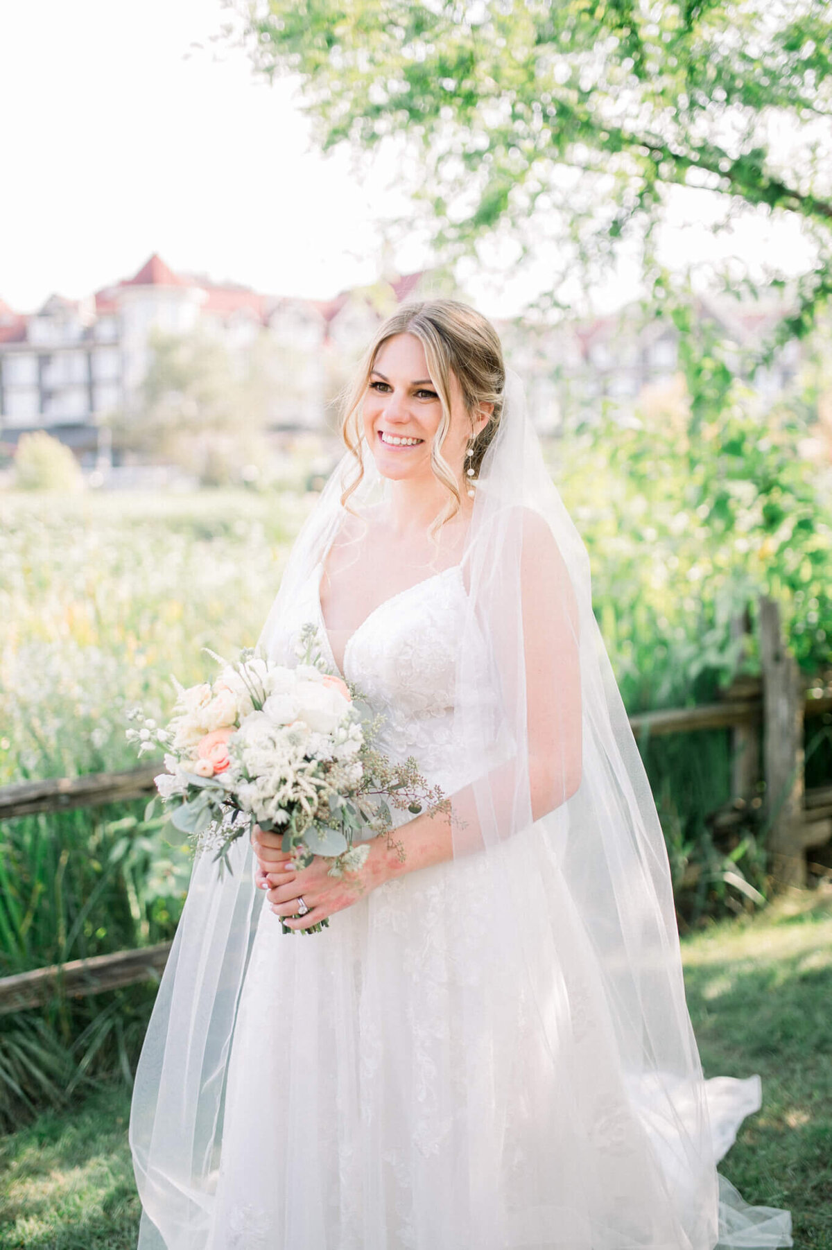 Brides portrait while holding flowers at her Toronto wedding