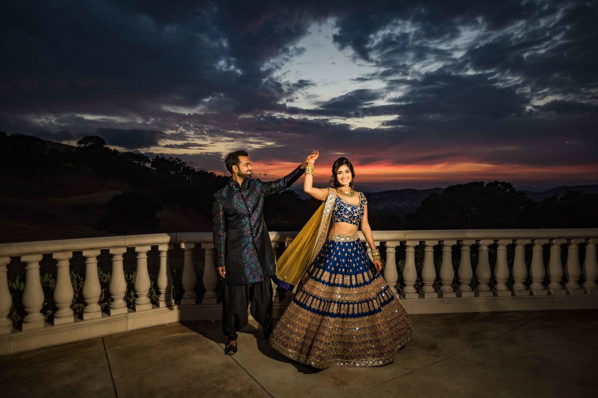 Indian bride twirling with sunset