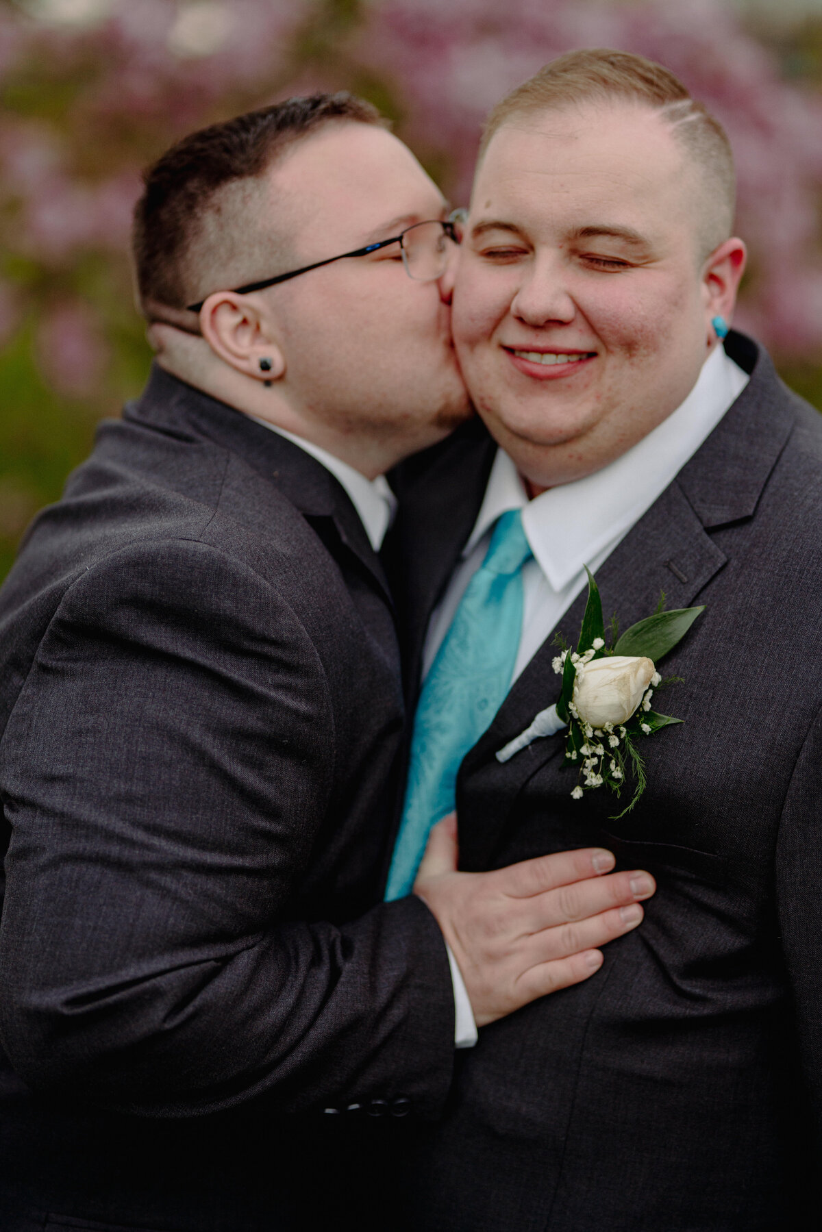 Groom leaning in to kiss their partner