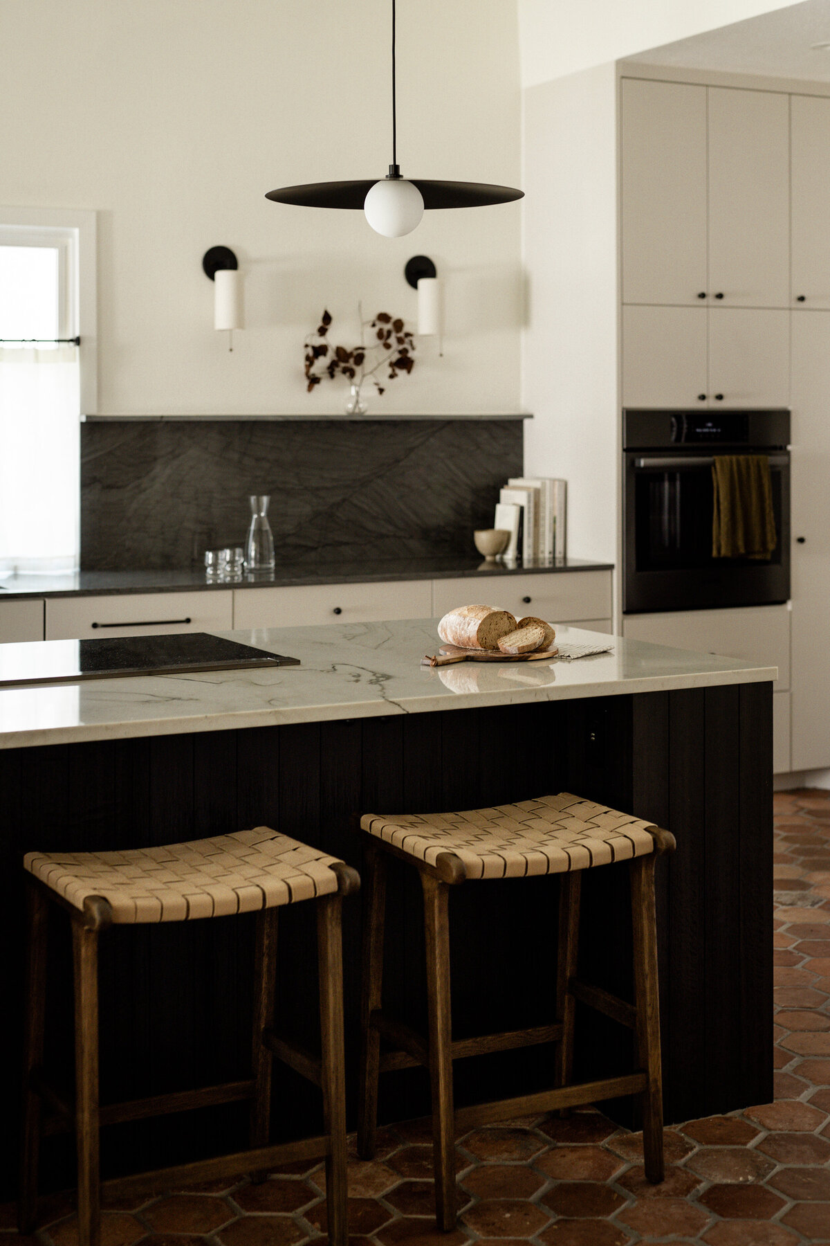 house-franc-kinney-row-cottage-kitchen-vintage-terracotta-tiles-patina-wood-island-quartzite-countertops-warm-bread-cooking-austin-texas