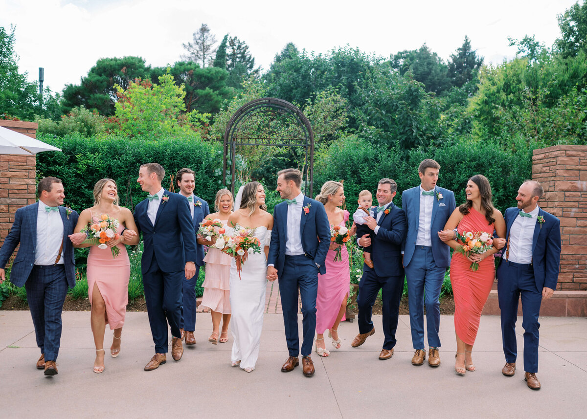 Bridal party laughs, smiles, and walks together towards the bridal party of Virginia Wedding Photographer - Erin Winter