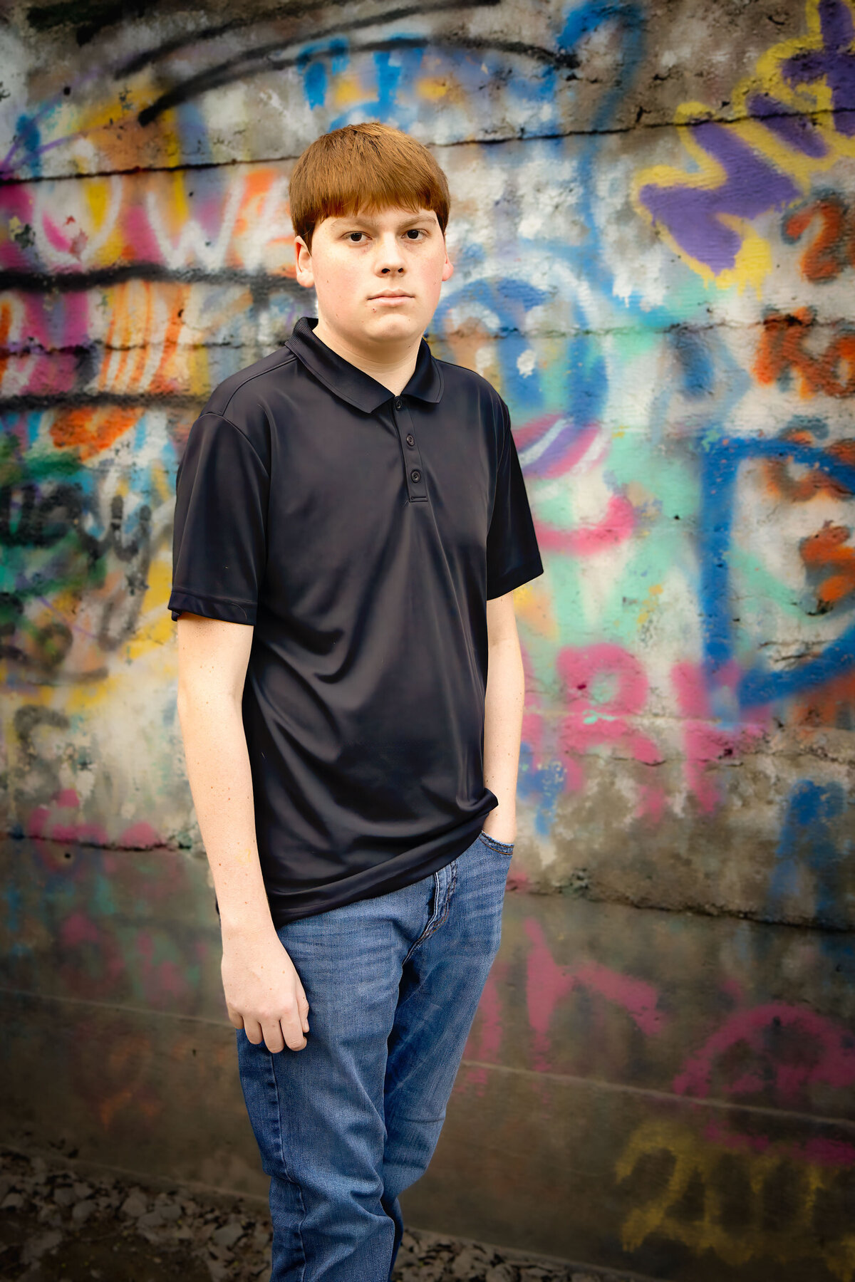 grad in front of graffiti wall denton county tx
