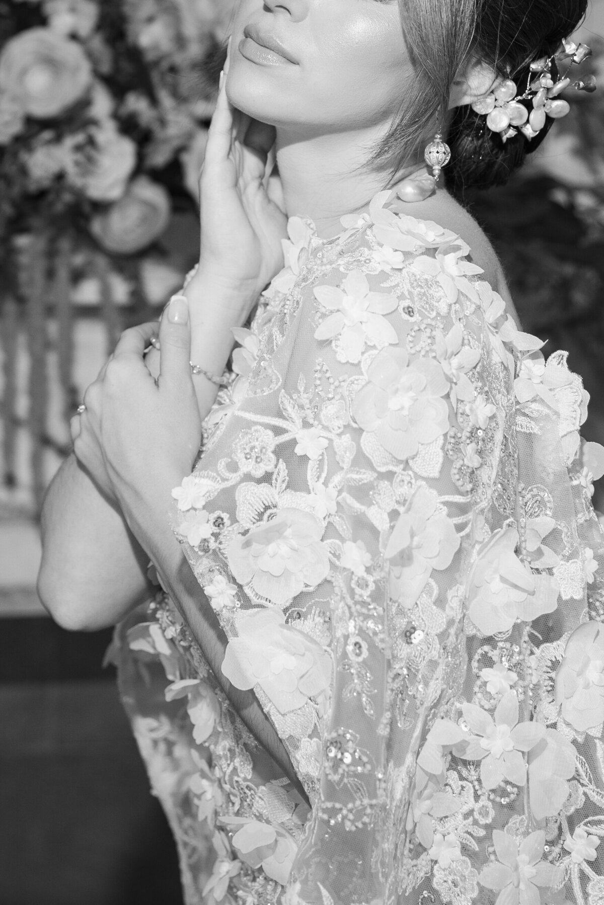 Elopement Wedding Packages Rhode Island | Kelsey Sheehan Photography Timeless Rhode Island Weddings | Black and white image of a person in an elegant, floral-patterned dress with hand near face. The scene conveys a sense of sophistication and grace.