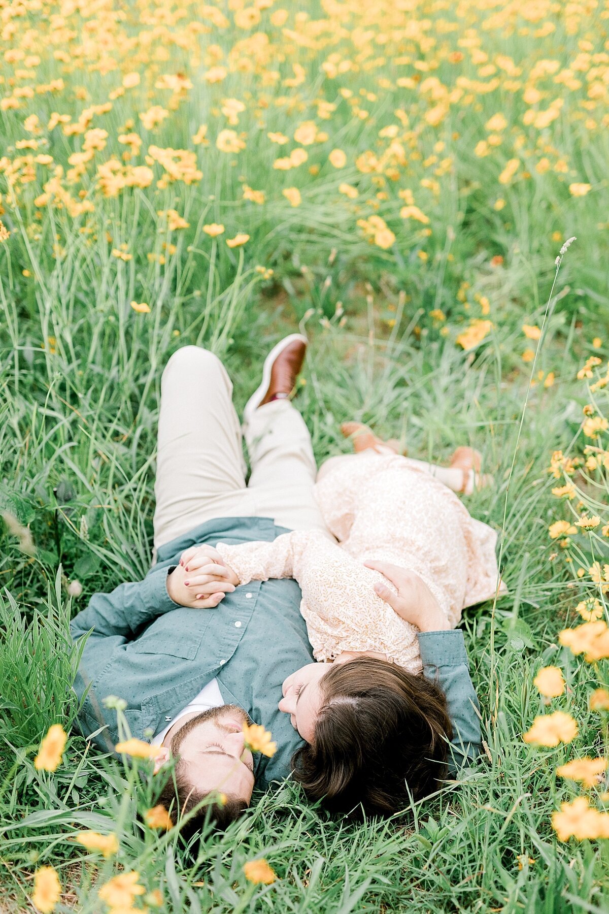 couple laying in yellow flowers