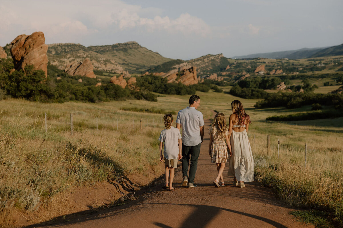 A joyful family photoshoot in Colorado’s scenic mountain meadows, capturing playful moments and natural connections against a stunning landscape