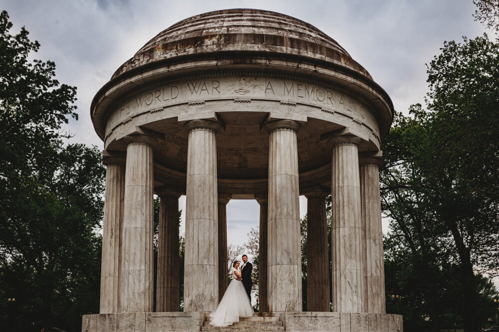 Maryland wedding photographer captures DCU wedding day with bride and groom standing on a historic monument together