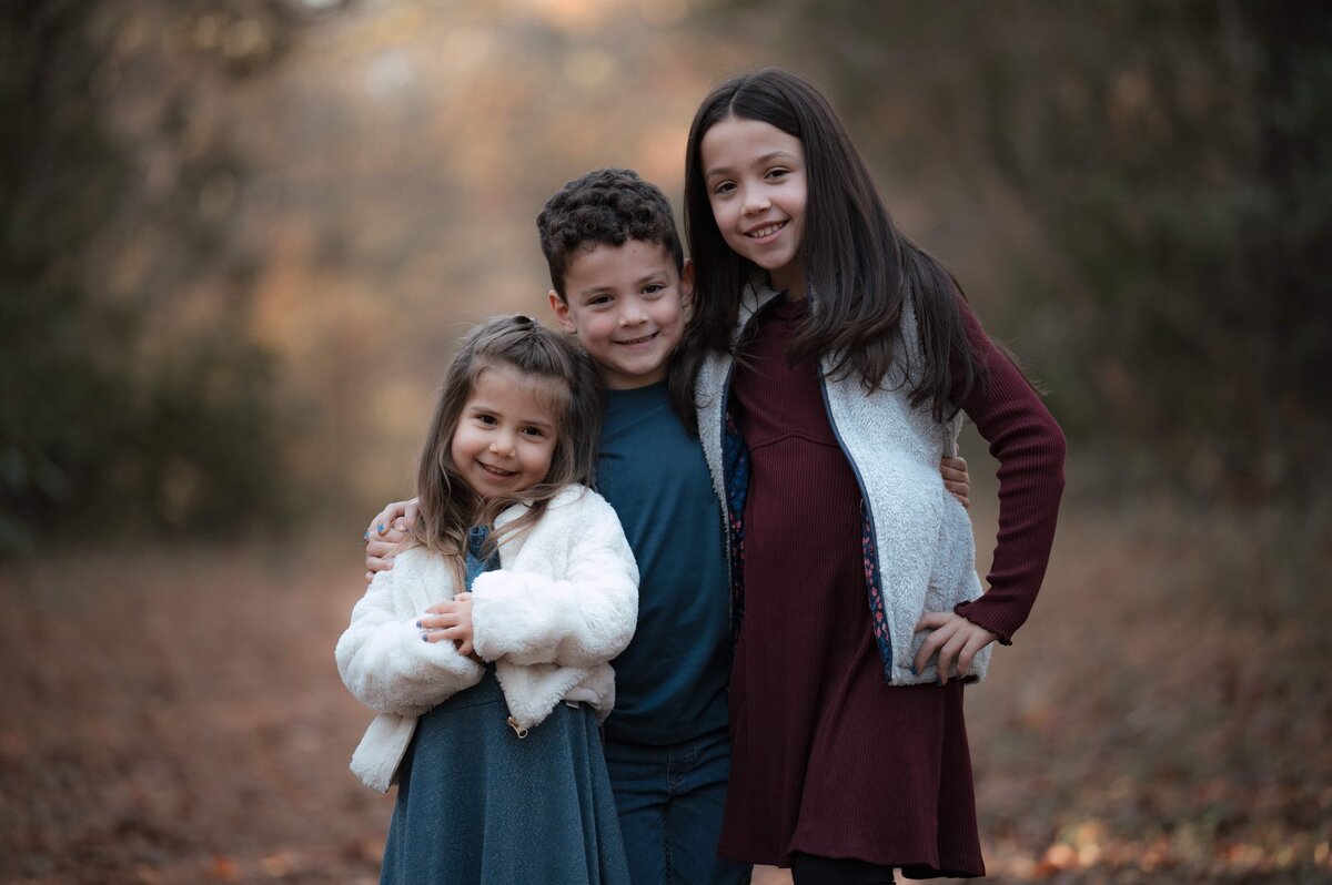 Natural family portrait in forest setting edited with Golden Embrace preset – earthy tones, gentle mood, and warm light for authentic lifestyle imagery.