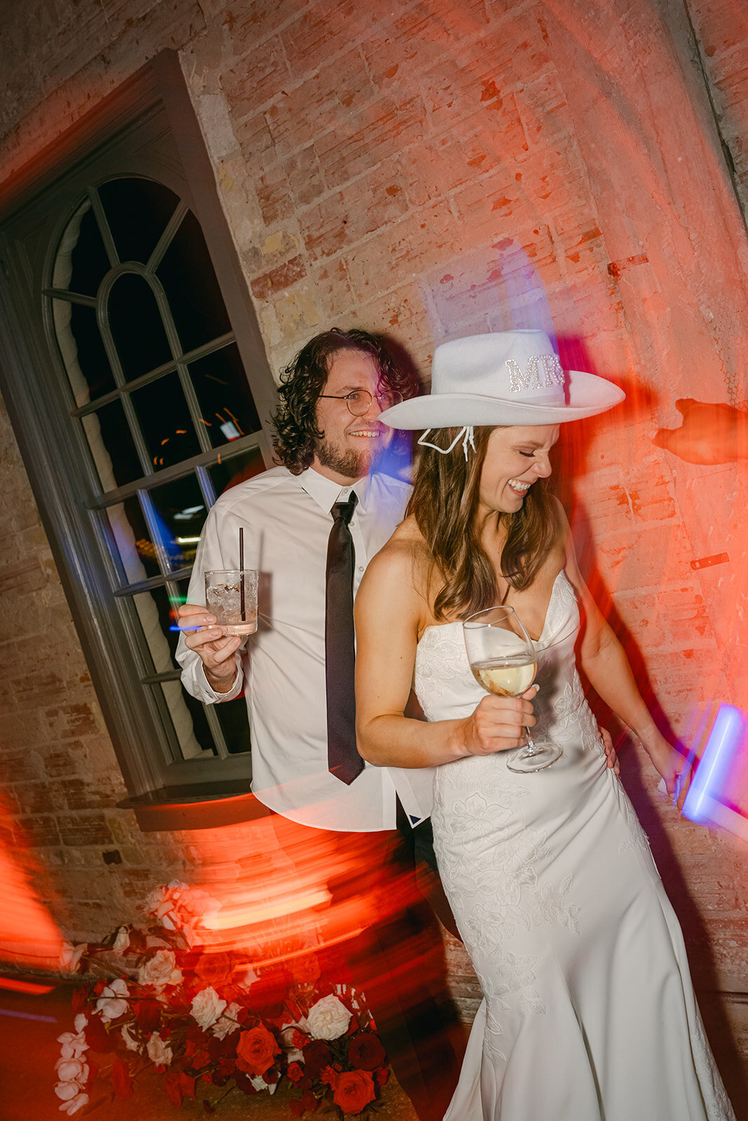 Modern couple posing together during glow-lit wedding celebration in The Battalion venue