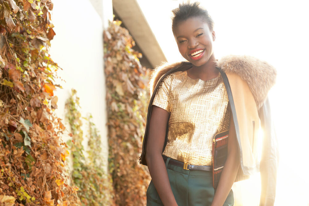 Fashion photography african american model with short hair Gold metallic shirt jewel tone fashion makeup for black women bright lip