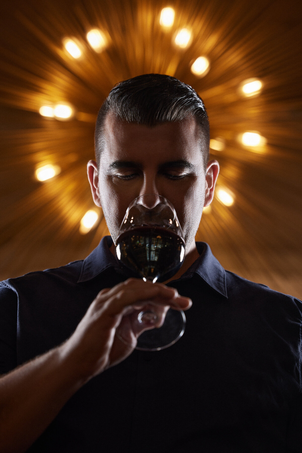 A man drinking a glass of wine