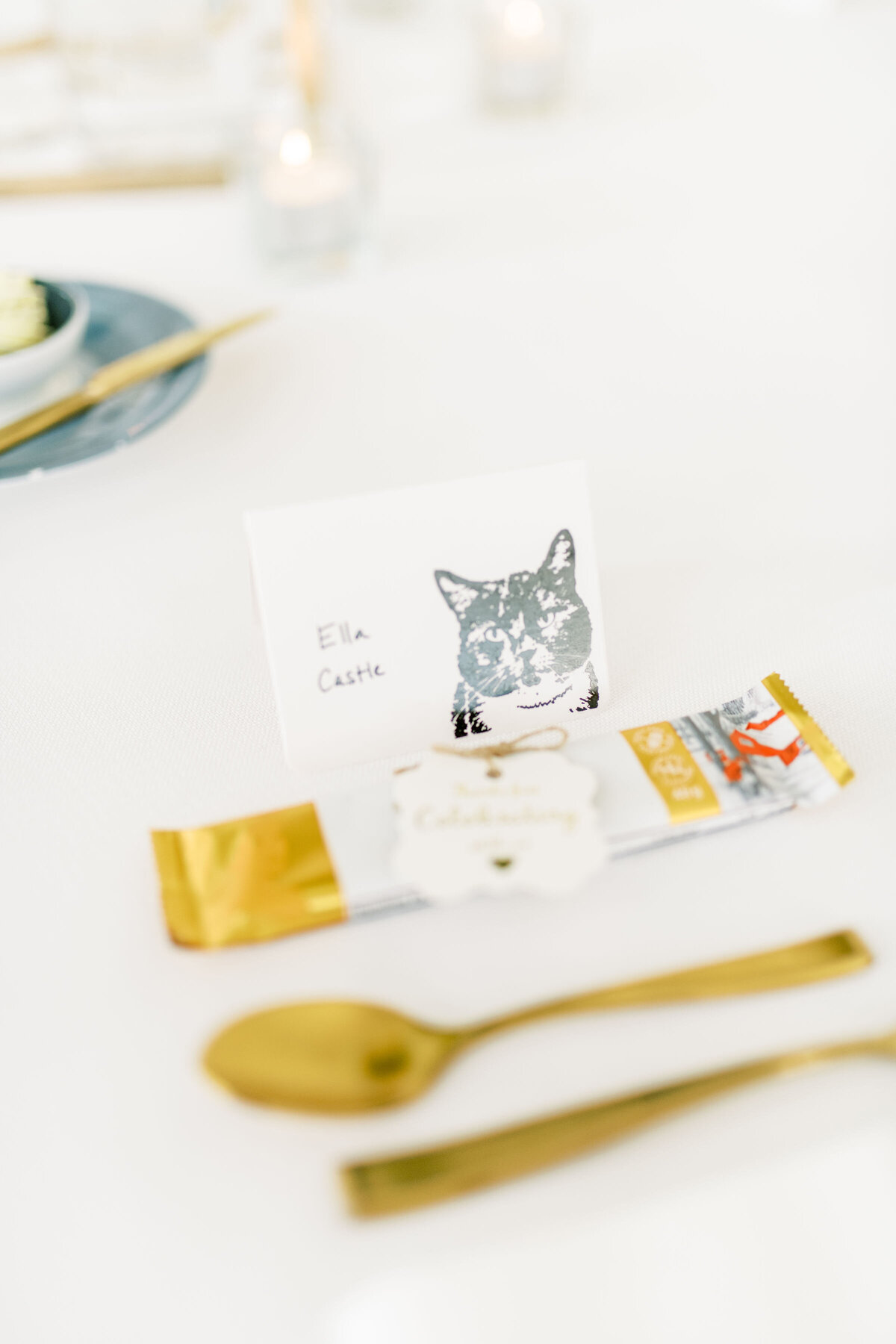 The bride incorporated her cat as favours for the tablescape at the pearle hotel. Gold stained cutlery