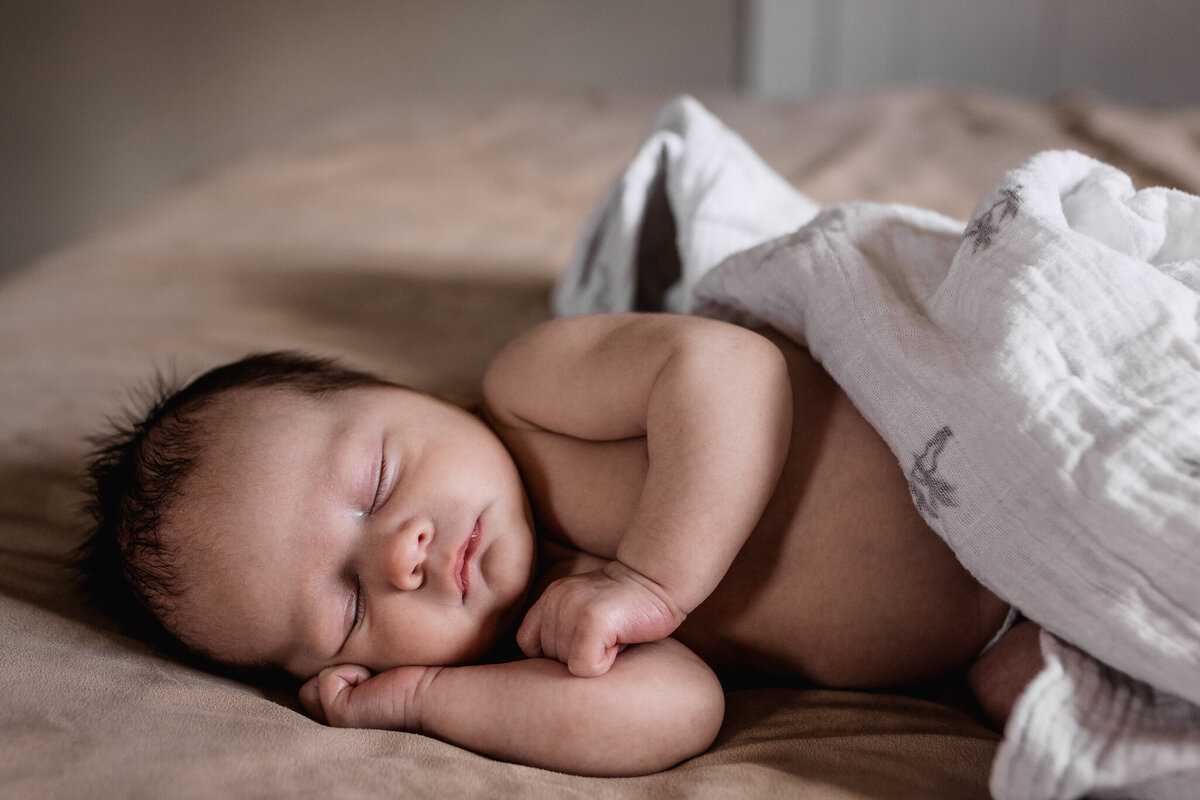 Newborn baby sleeping on bed a in-home newborn photo session by lisa smith photography