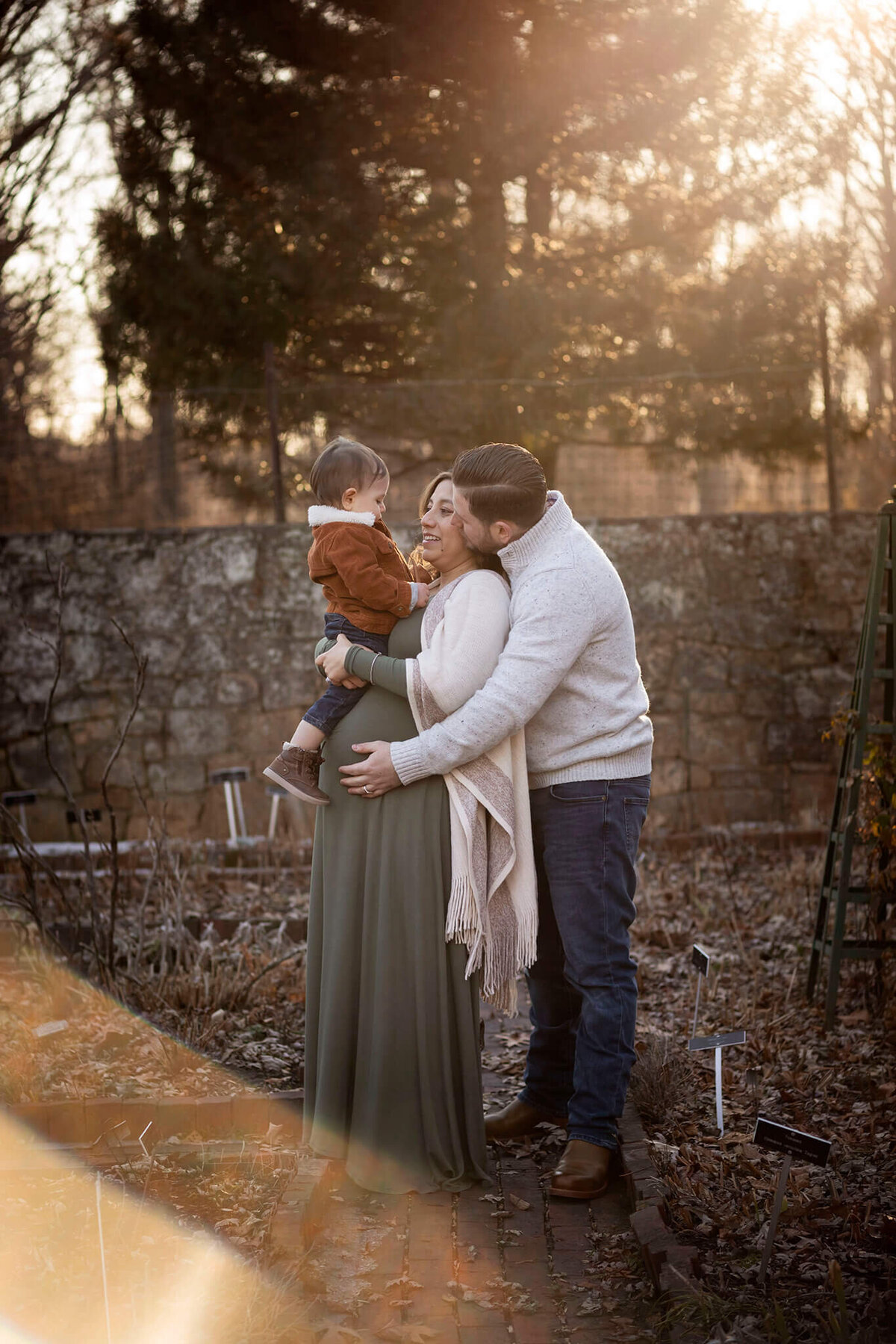 NJ maternity photographer captures family playing together in garden