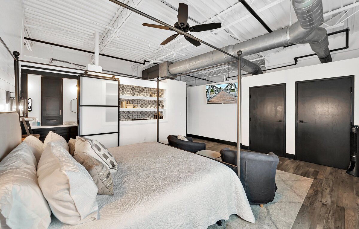 Master bedroom with private bathroom in this two-bedroom, three-bathroom top floor corner loft in the historic Behrens building in downtown Waco, TX