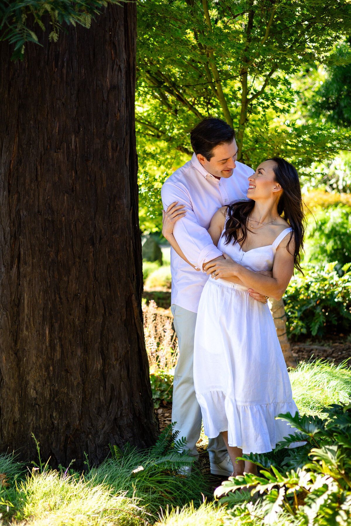 Couple standing by redwood tree smiling at each other, Bay Area Family Portfolio – Ellobelle Photography