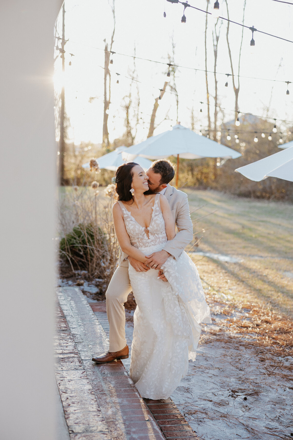 Couple kissing at sunset during their outdoor wedding in North Carolina 