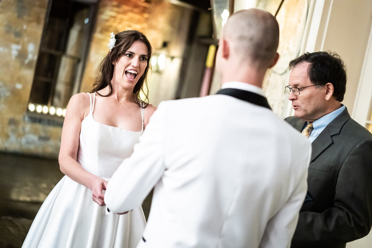 Bride laughs during wedding ceremony