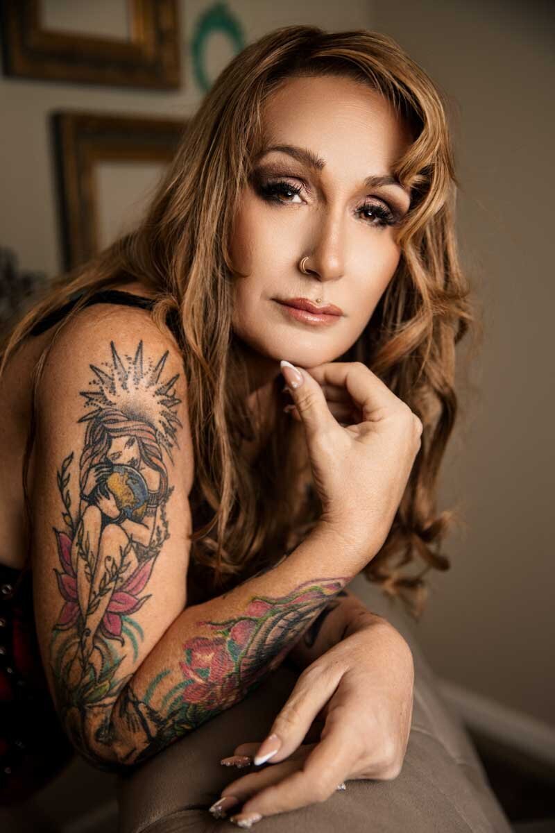 Boudoir portrait of woman showing off her tattoos