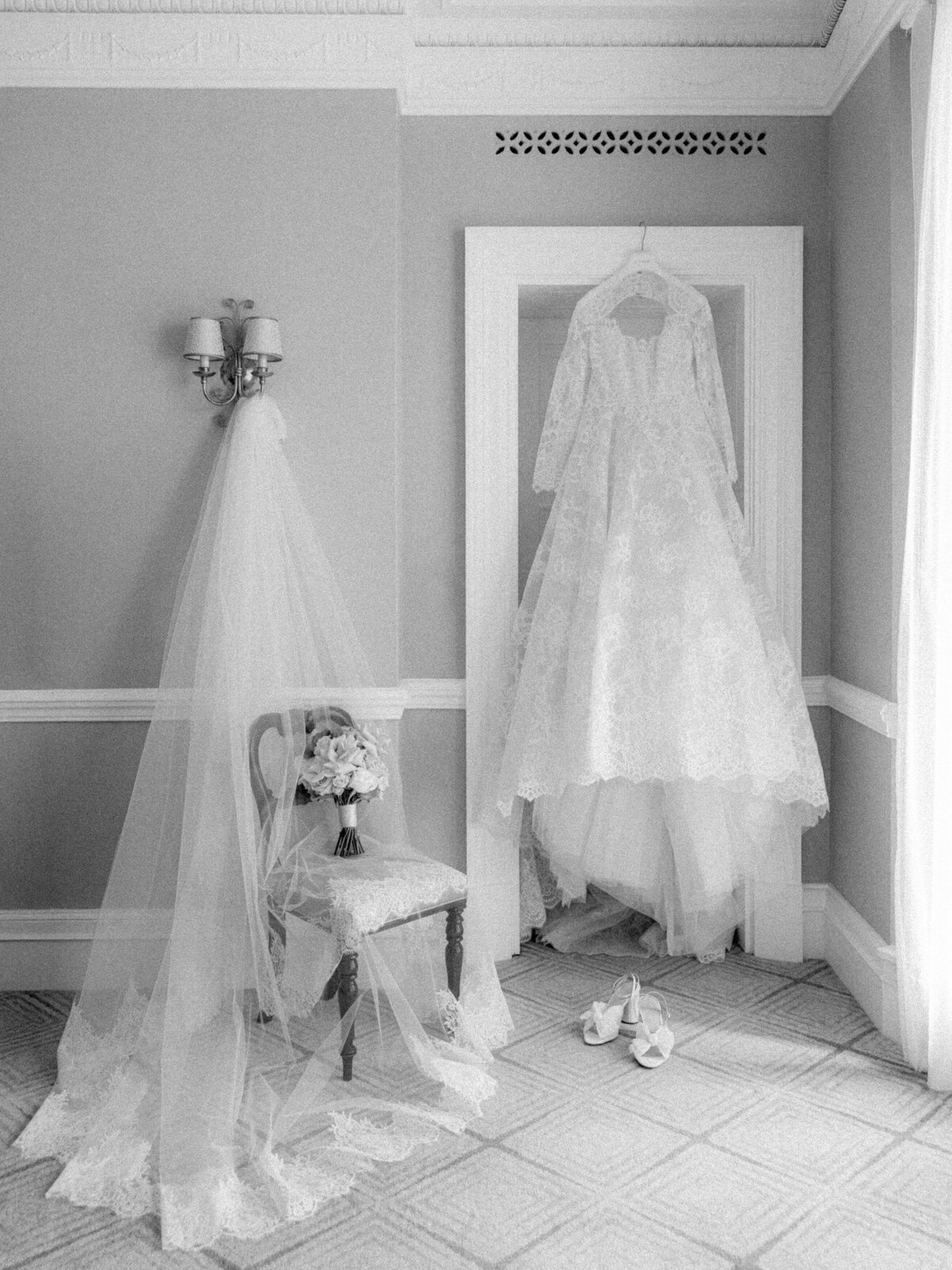 wedding dress hanging from door