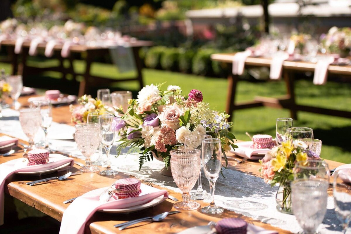 Reception table at outdoor garden wedding with beautiful flowers.