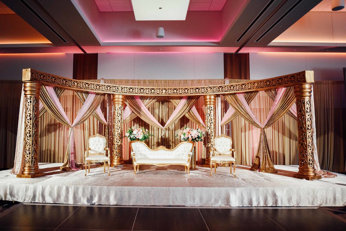Dramatic gold stage for indian wedding reception