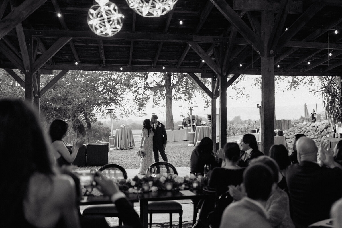 A newlywed couple enjoys their first dance at an intimate vineyard wedding reception in Napa, CA.