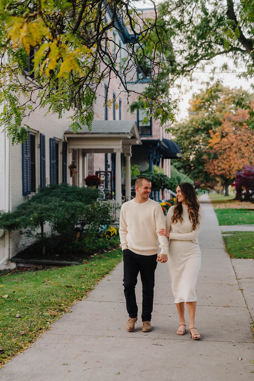 Couple walking along in a neighborhood in Finger Lakes NY
