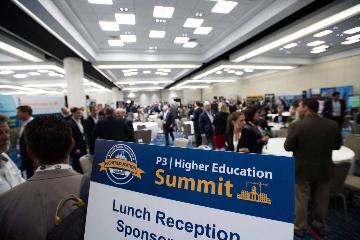 A sign is displayed during breakout session as people mingle and converse