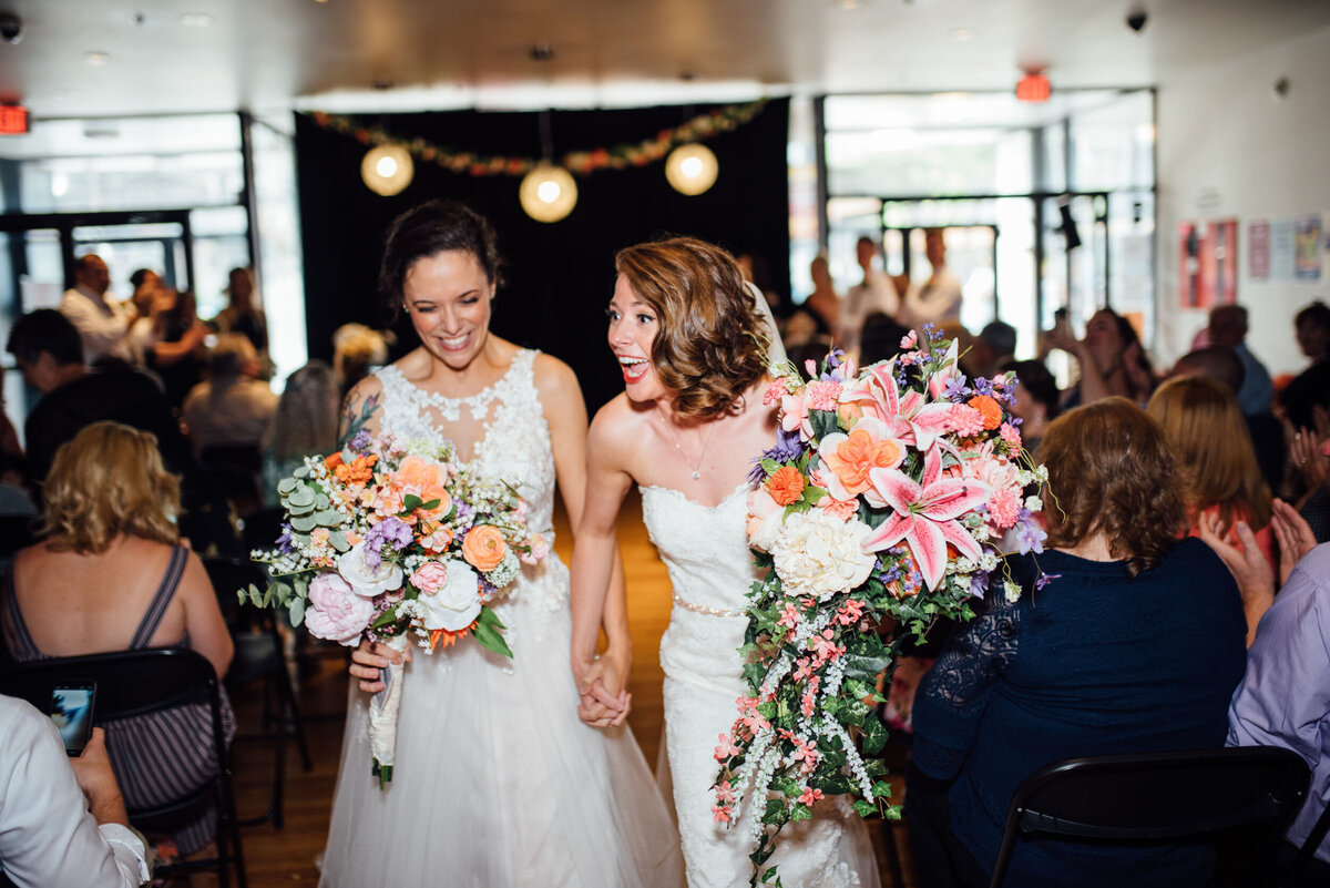 two brides walk down the aisle in portland maine