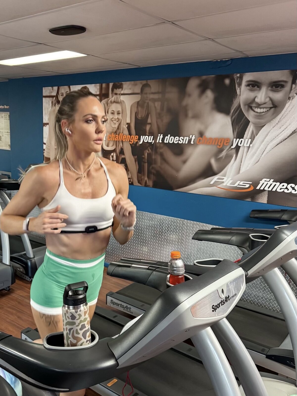 Libby running on a treadmill wearing a heart rate strap