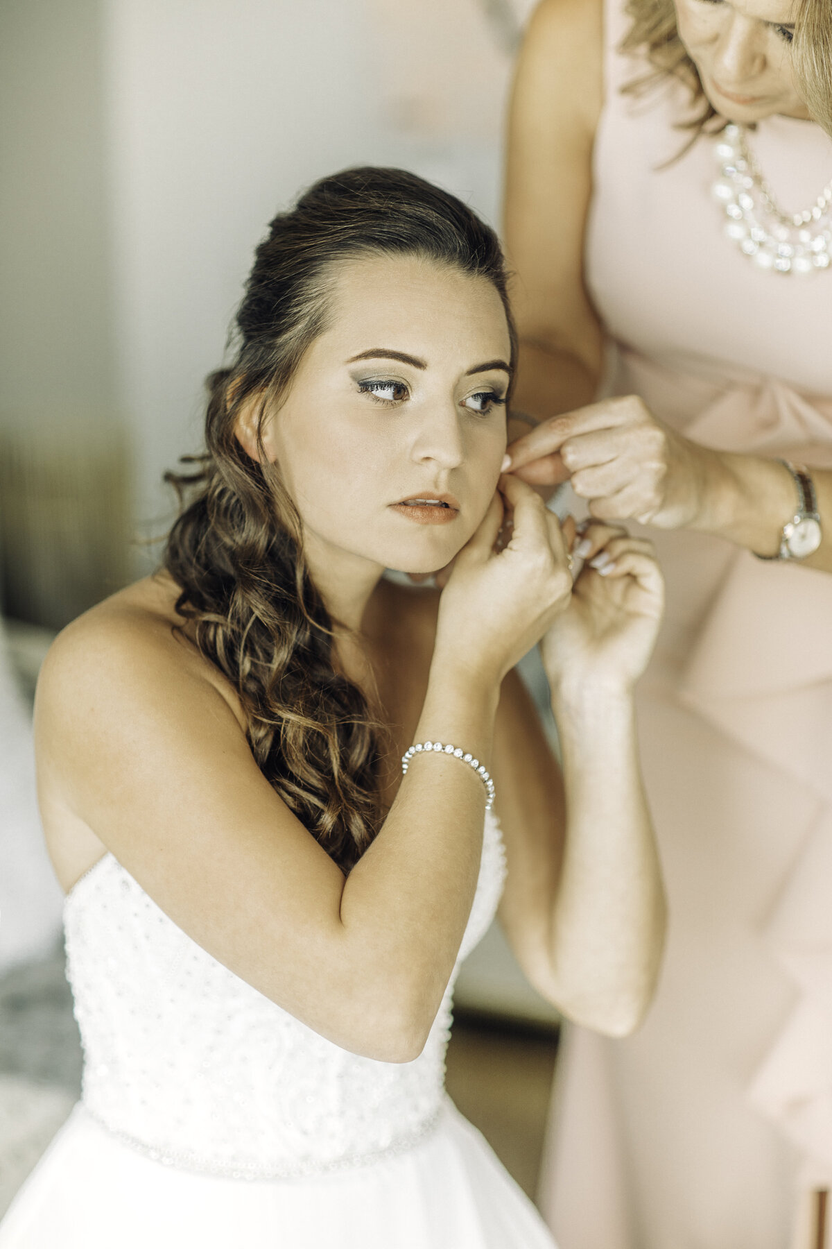 Wedding Photograph Of Woman Having Her Earrings Fixed Los Angeles